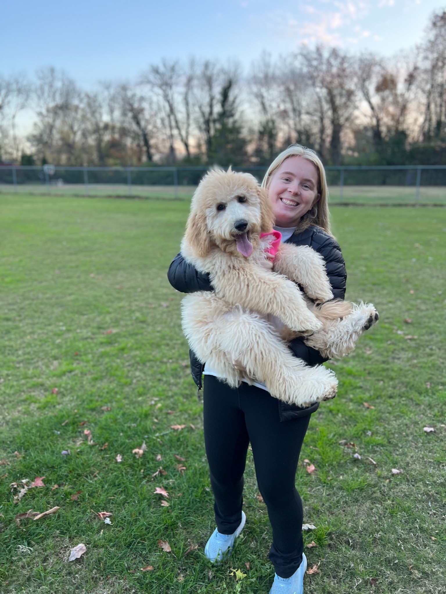 Birdie & Co. founder holding a fluffy dog outdoors